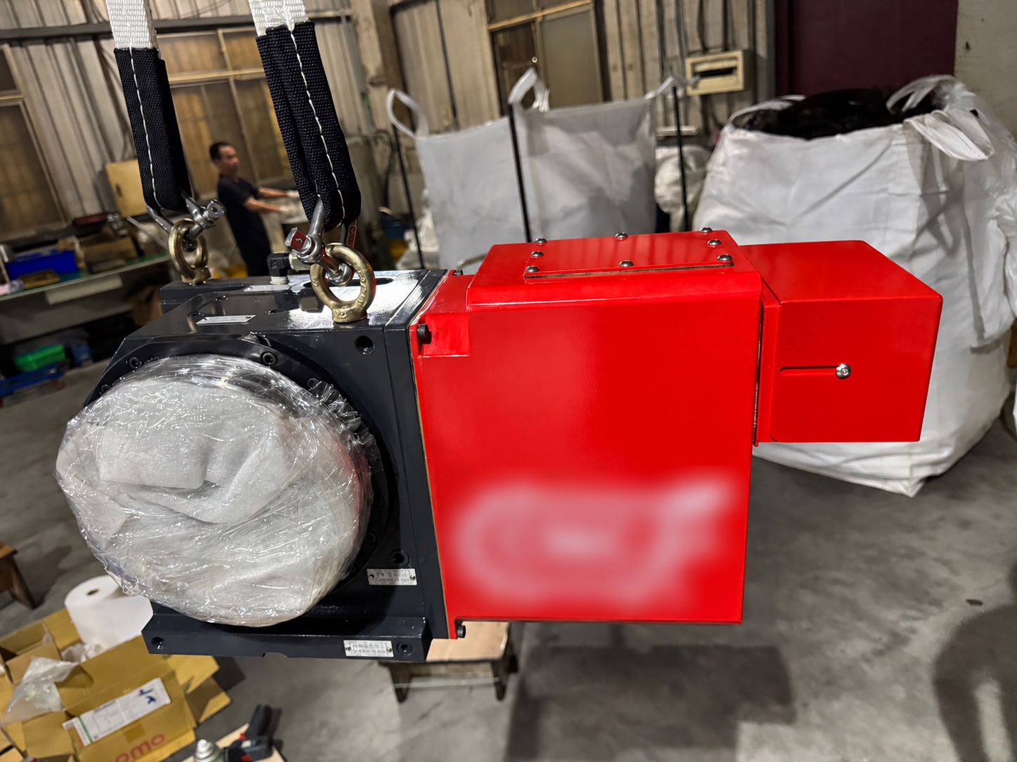 Completed rotary table with red motor cover and protected faceplate; customer logo blurred