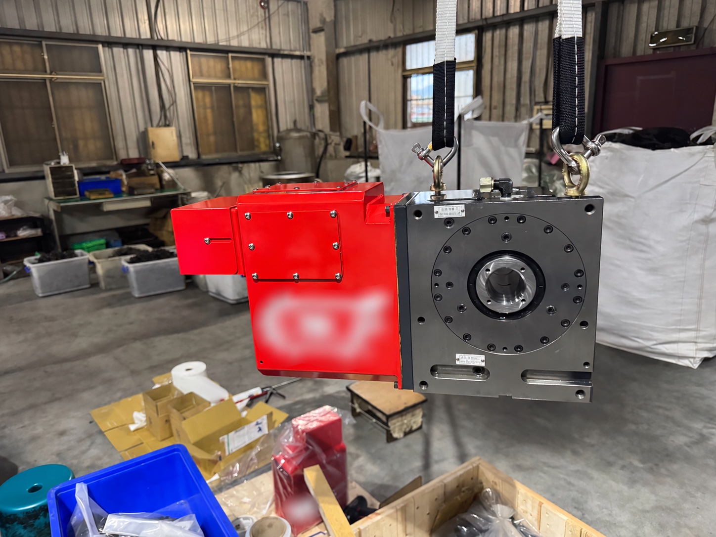 Rear view of rotary table and red motor cover; customer logo blurred